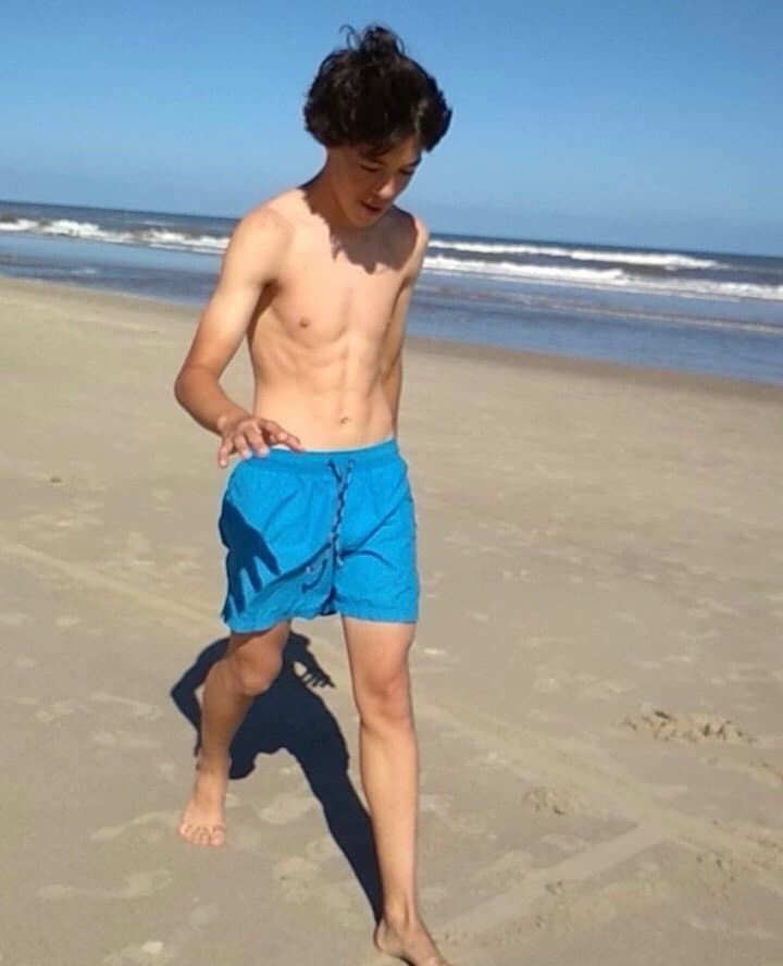 Facundo de chico, caminando descalzo por la playa
